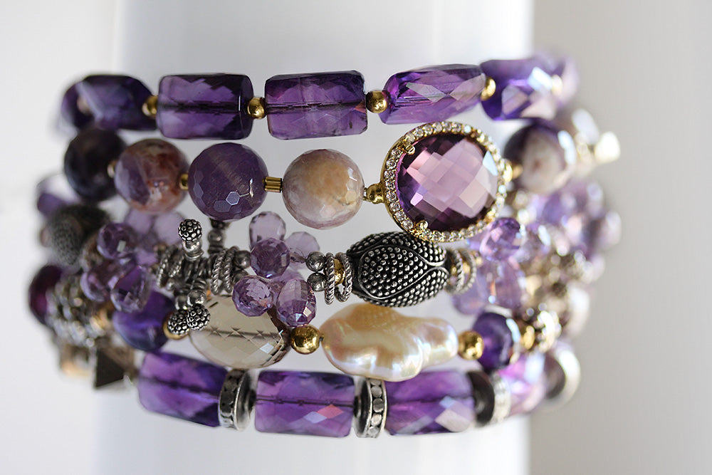 Bracelet stack of amethyst, pearl, and CZ accent charms.