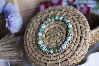 6mm Dragon Vein Agate Stretch Bracelet on basket surrounded by flowers. 