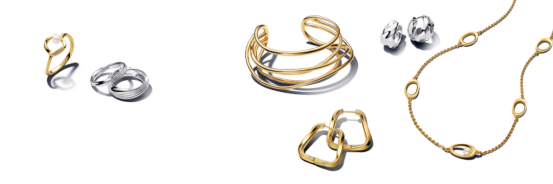 Pandora Essence collection featuring modern gold and silver jewelry designs, including a pearl-accented gold ring, minimalist silver stacking rings, sculptural gold cuff bracelet, geometric hoop earrings, polished silver studs, and a delicate gold chain necklace with oval and pearl details.