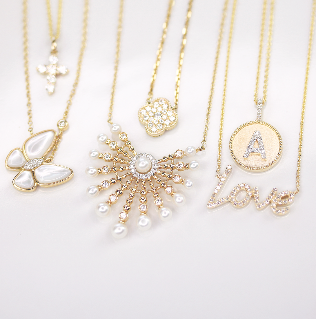 Madison L dainty necklaces crafted from 14k gold and adorned with diamonds, shimmering beautifully in the sunlight.