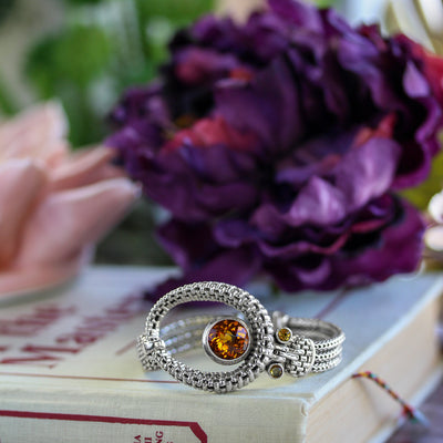 Bali Citrine Asymmetric Oval Bracelet featuring a bold faceted orange-yellow citrine gemstone set in a textured sterling silver oval design with intricate detailing, artisan handcrafted November birthstone jewelry.