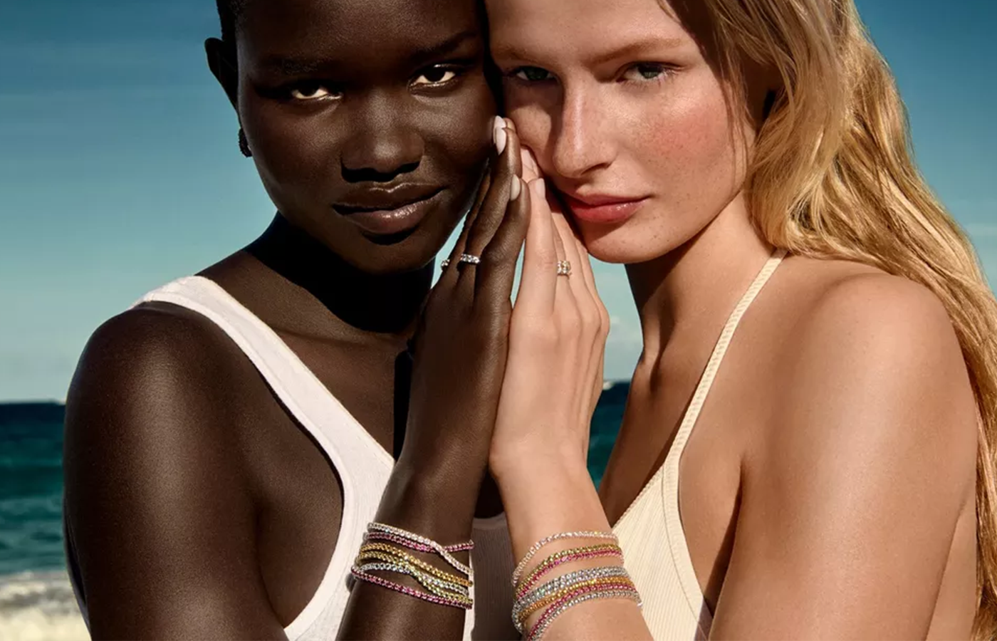 Two models wearing Pandora Timeless collection jewelry, showcasing sparkling eternity rings and multicolored pavé-set bracelets in sterling silver and gold tones — radiant, stackable styles perfect for everyday elegance and special occasions.