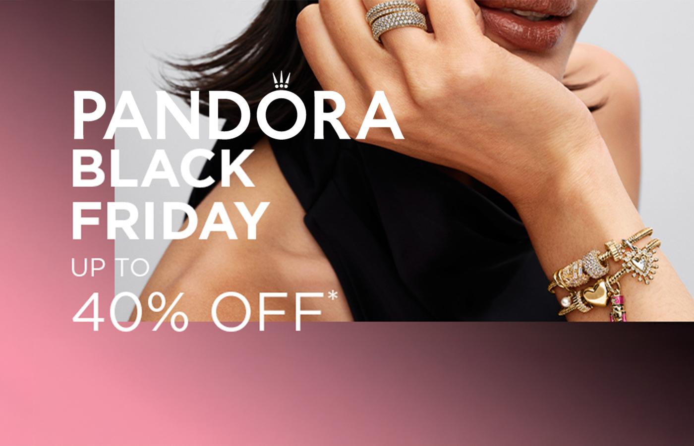Pandora Black Friday Up to 40% Off featuring model with gold charm bracelet on bold gradient background.