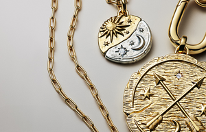 Pandora Talisman Collection gold and silver medallion necklaces featuring celestial sun, moon, and star designs with sparkling accents, paired with bold link chains for a symbolic, statement jewelry look.