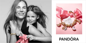 Mother and daughter sharing a joyful hug with Pandora gift box and celestial-themed Pandora charm bracelet featuring moons, stars, and sparkling charms — styled with a pink satin ribbon and note reading 'I want the moon for my mom' — perfect Pandora Mother’s Day or gifting campaign.