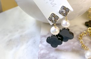 Two drop earrings with black four leaf clover and styled pearls