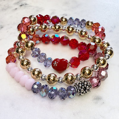 Valentine's Day sparkly stack of Swarovski Crystal Elements bracelets, pink, reds, purples, and red enamel hearts, with 14kt gold-filled accents.  
