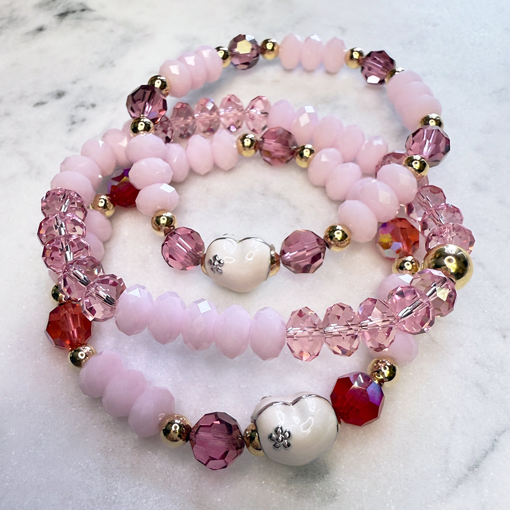 Valentine's Day sparkly stack of Swarovski Crystal Elements bracelets, pink, reds, white enamel hearts, with 14kt gold-filled accents. 