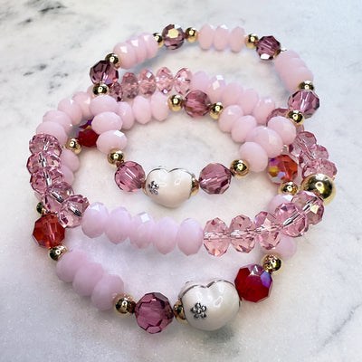 Valentine's Day sparkly stack of Swarovski Crystal Elements bracelets, pink, reds, white enamel hearts, with 14kt gold-filled accents. 