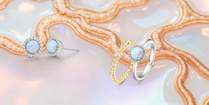 Opal birthstone jewelry featuring sterling silver halo stud earrings, a silver opal halo ring with sparkling accents, and a gold beaded opal band, Elisa Ilana handcrafted October birthstone jewelry with iridescent gemstones.